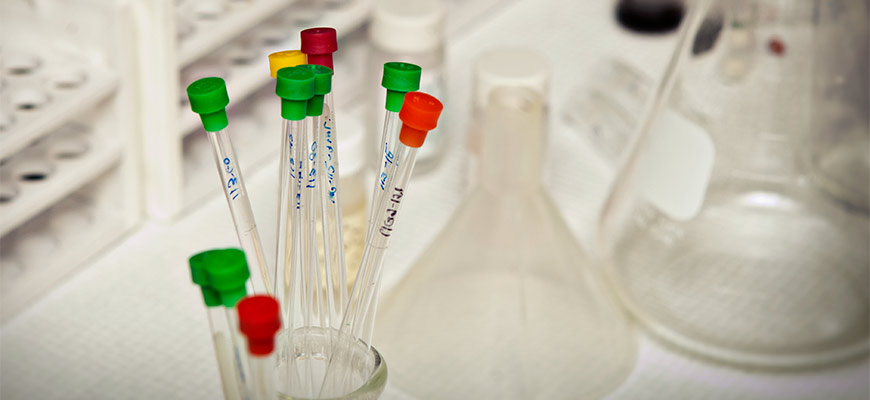 test tubes with colorful tops in a beaker