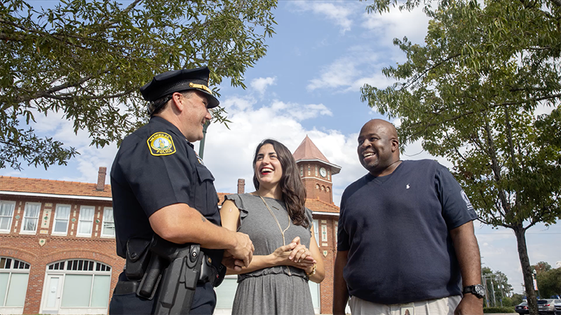 Kassy Alia with officer and community member