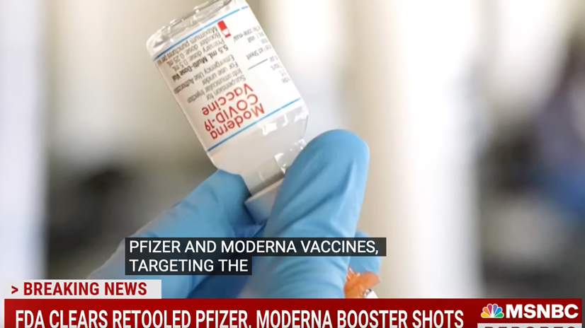 health care worker wearing gloves holds a moderna vaccine vial upside down