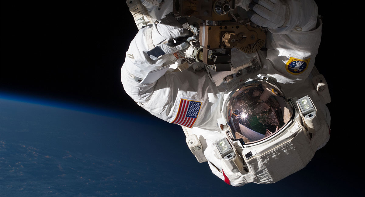 Astronaut floating upside down in space.