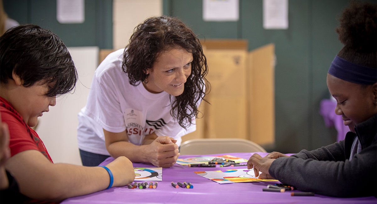 teacher working with kids at the University of Possibilities program