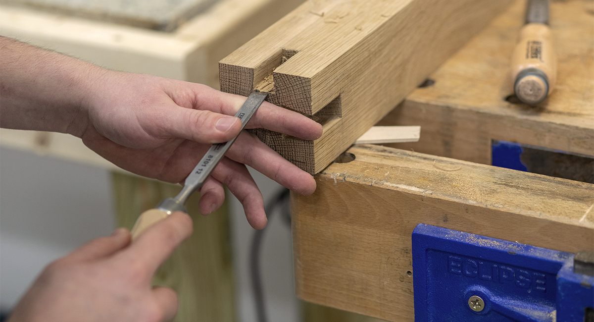 hands carving a piece of wood