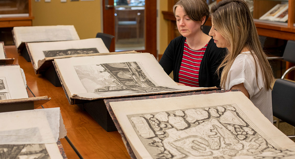 two librarians look at rare books