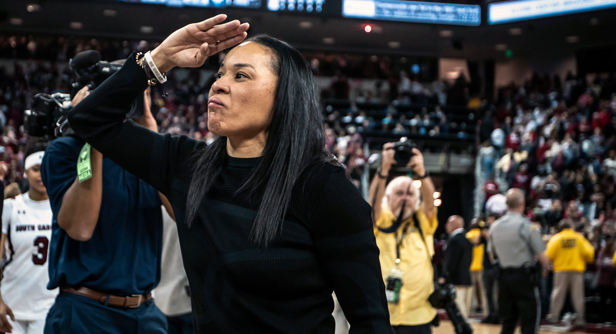 a'ja wilsona and dawn staley hold a trophy