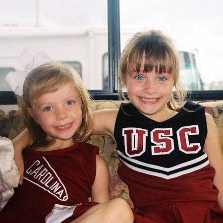Caroline and Anne Perry as young girls dressed in Gamecock cheerleader outfits