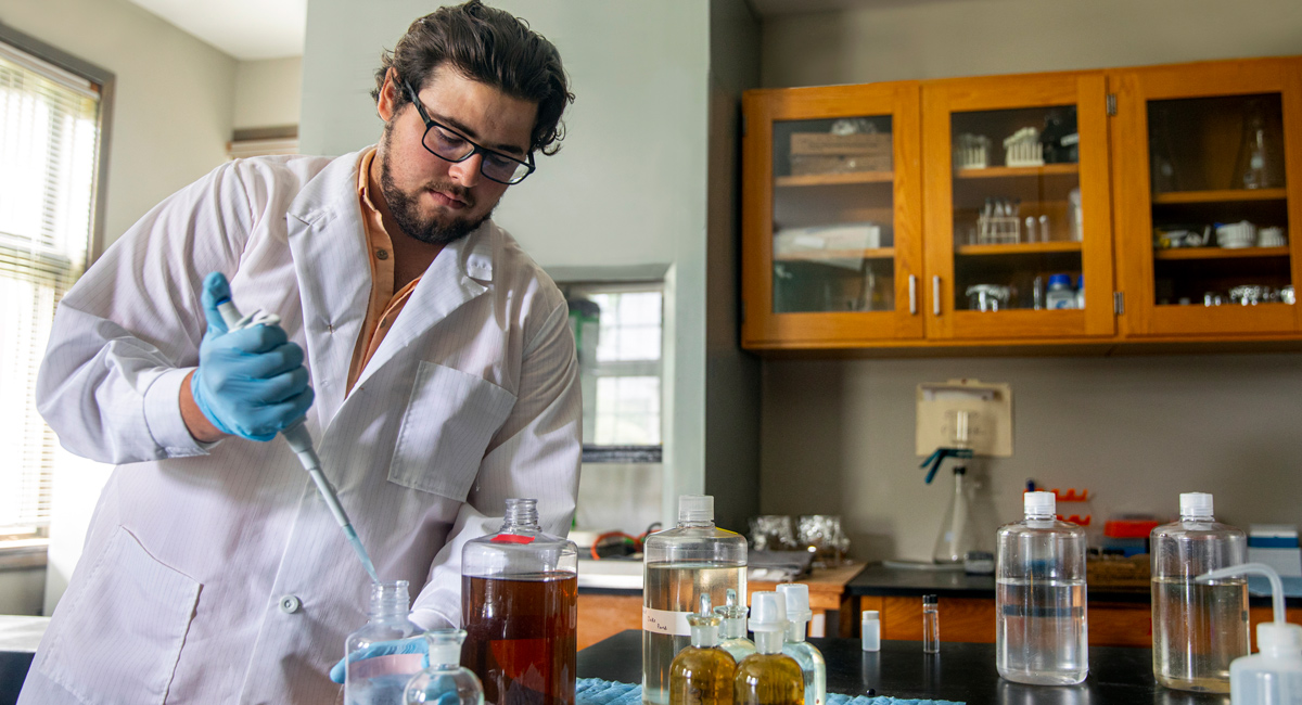 C.J. Szewczyk works in the lab at Baruch