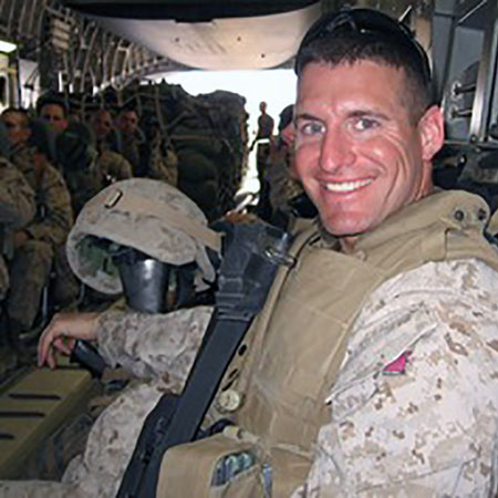 James Mann in fatigues flies on a troop transport.