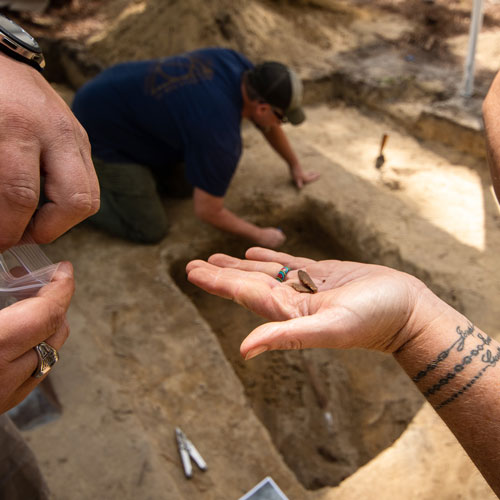 Archaeologists uncover flattened musket balls from the historic Camden battlefield.