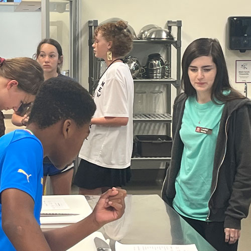 Students read instructions during summer camp.