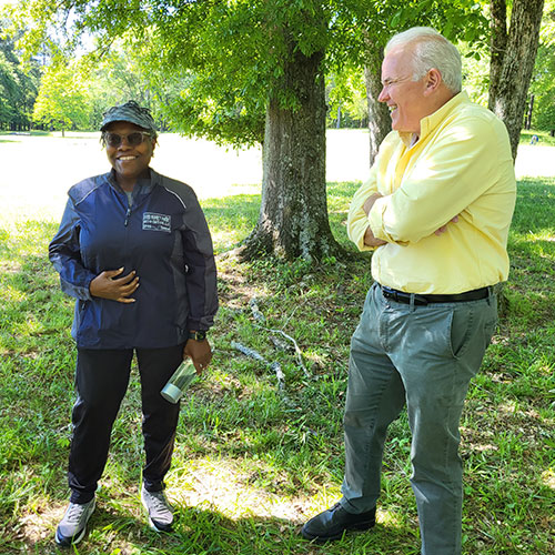 Cynthia Green and Charlie Smith, descendants of John Herman Kinsler at the the cemetery site on the former Kinsler plantation.