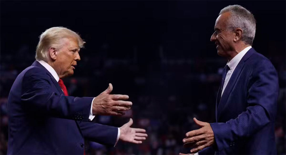 Two men in blue suits greet each other with open arms.