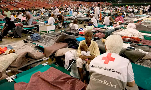 Evacuees from Hurricane Katrine in cot-filled storm shelter