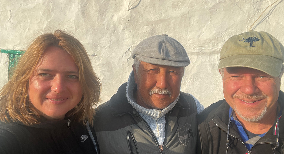 Three people from shoulders up glowing in light of sunset