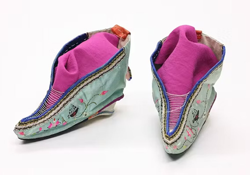 A pair of Chinese lotus shoes (for bound feet) in colorful pink and green