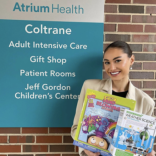 Romano displays a science box outside of a children's hospital.