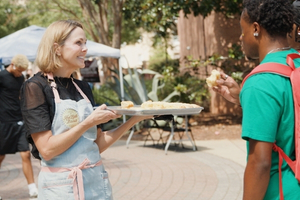Carrie Morey serving biscuits to a student