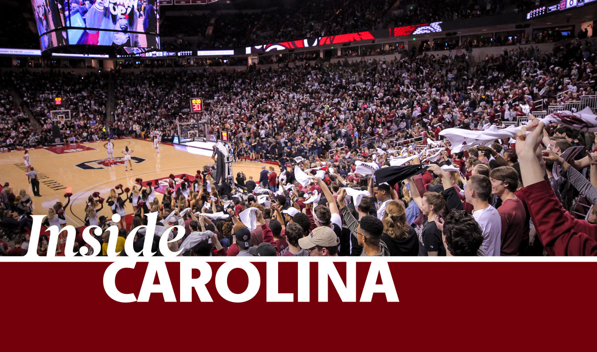 The crowd at a basketball game inside the Colonial Life Arena and the text Inside Carolina.