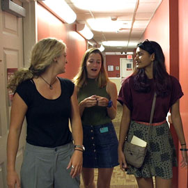 students talking in a hallway