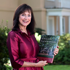 First Lady Patricia Moore-Pastides holding her new book