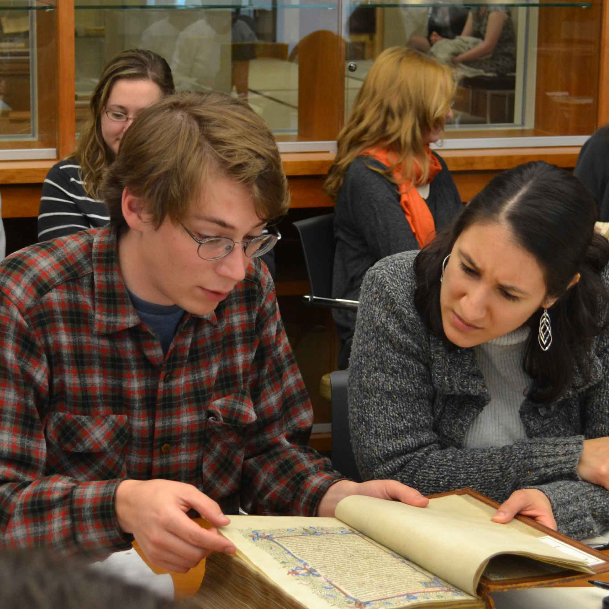 scholars studying medieval manuscripts