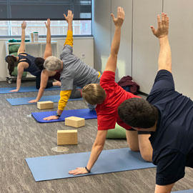 People practicing yoga at the calm oasis space in the health center