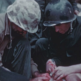 Medics giving medical attention to a patient during the Battle of Iwo Jima. 