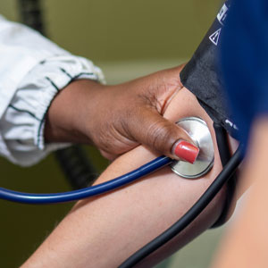 health care provider taking blood pressure of patient