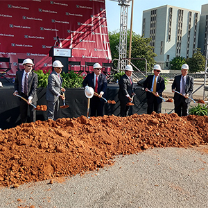University leadership take part in the groundbreaking ceremony at the Campus Village housing site on Wednesday, May 26.