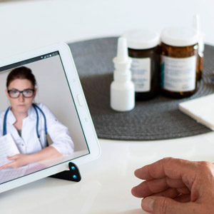 stock image of telehealth with doctor depicted on electronic device