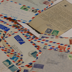 Letters in air mail envelopes from Otto Frank to Cara Wilson-Granat spread on a table.