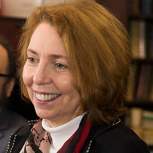 Eugenia Broude smiles while meeting with other faculty members. 