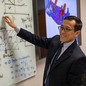 Stanley Ling writes on a whiteboard.