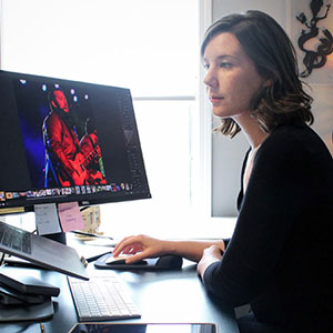 Rebecca Rebl works at her computer to design graphics