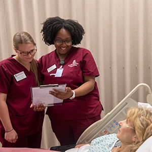 USC student nurses at bedside of a patient