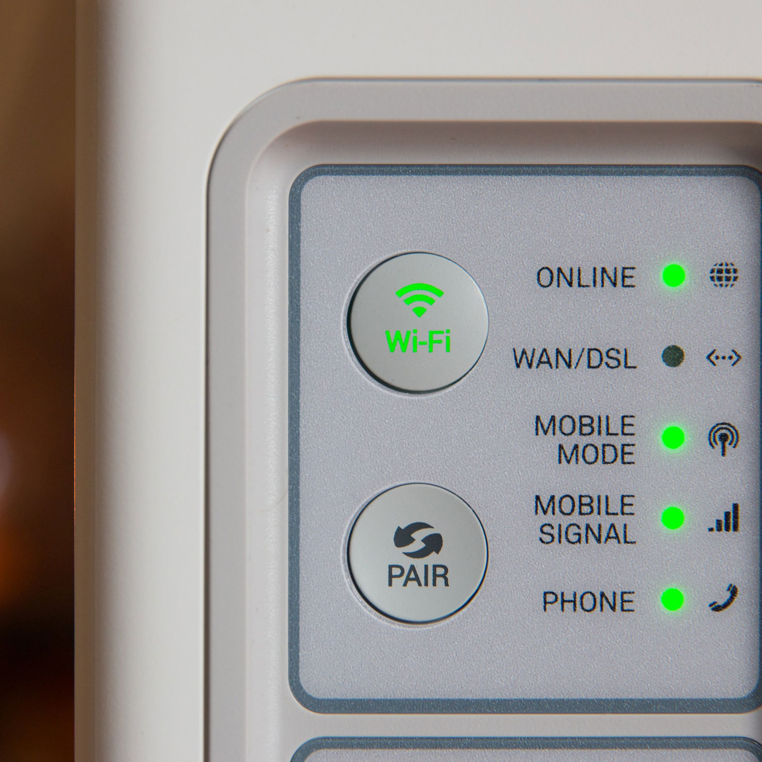 A wi-fi symbol lights up green on a router.
