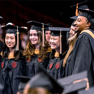 students in caps and gowns at commencement