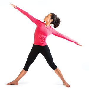 A woman with arms outstretched doing yoga.