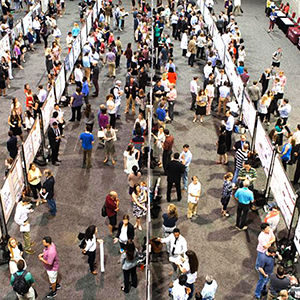 lines of people presenting and conversing at a convention