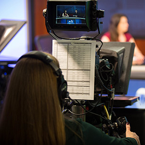 Person operating a television broadcast camera.