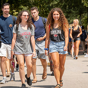 students walk across campus on the first day of class
