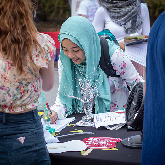 Girl signing up for a student organization.