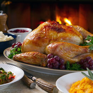 A dinner with a turkey is set on a table. 