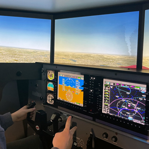 a pair of hands operate controls in a flight simulator