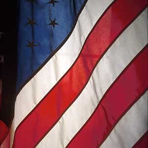 Close up of American flag. Stars in left corner and stripes on right side. 