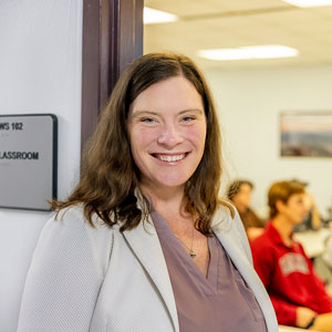 Katherine Ryker smiles in front of a classroom