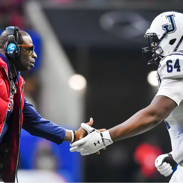 Jackson State Tigers coach Deion Sanders shakes hands with right tackle Deontae Graham 
