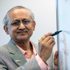 Amit Sheth stands at a white board with a marker