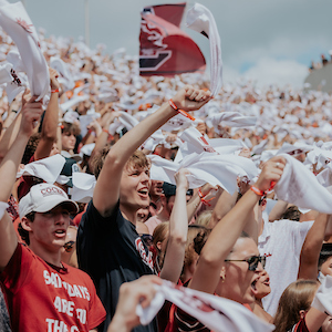 students at Williams-Brice waving white towels