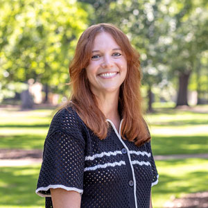 Vanessa Kitzie smiles in a short sleeved shirt on the sunny Horseshoe