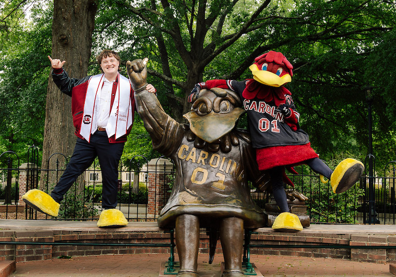 Brayden Hensley and Cocky pose at the Cocky statue at the University of South Carolina